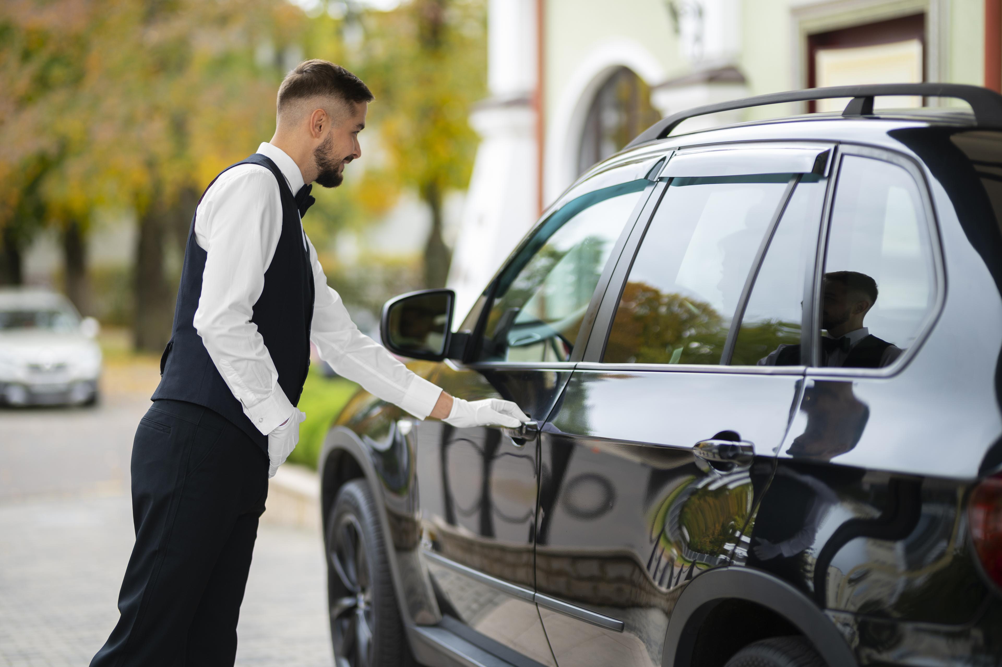 Valet assisting a guest out of the car